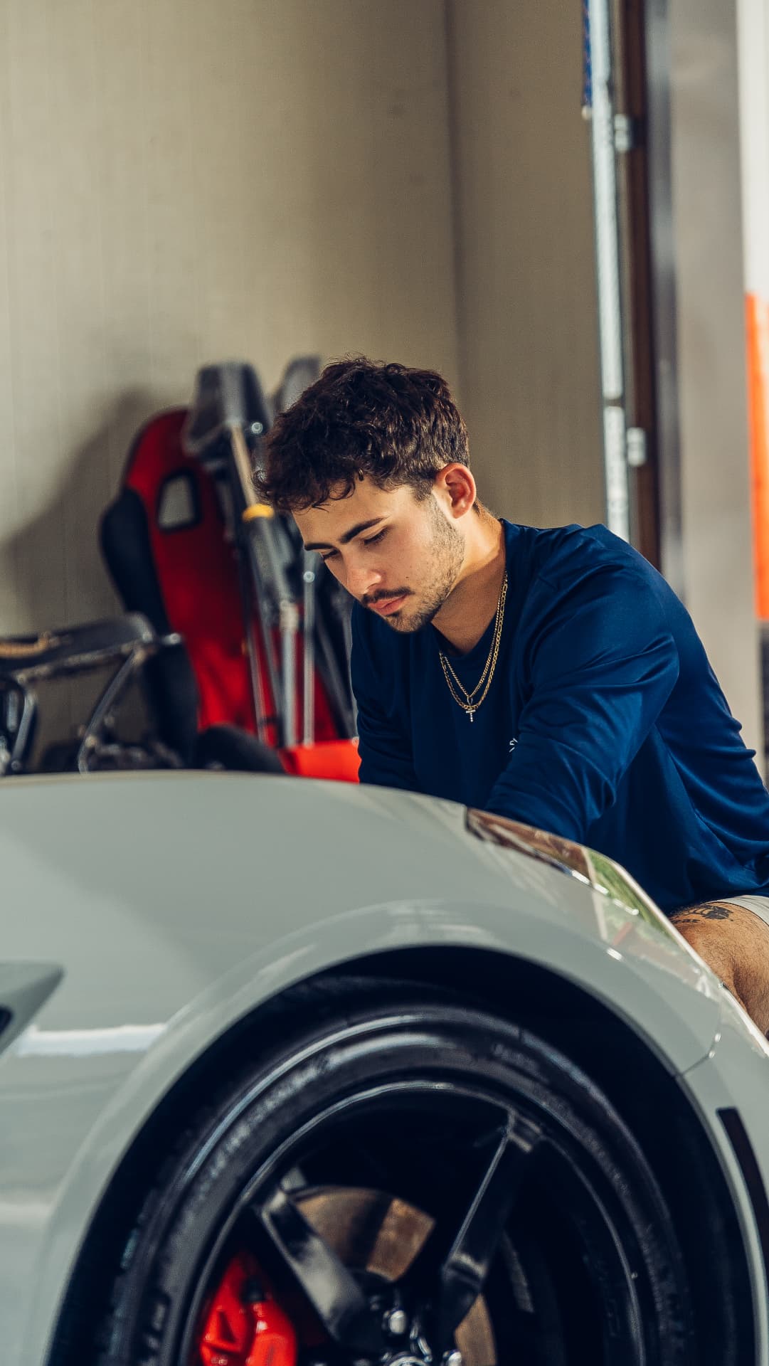 Braylon, owner of BJ's Details, detailing a sports car in New Philadelphia, Ohio
