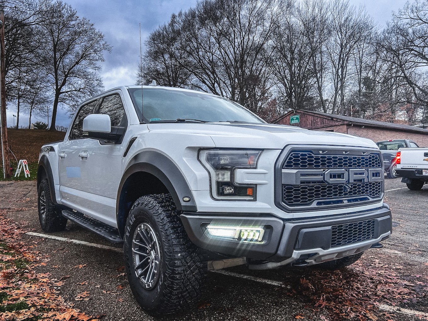 White Ford F-150 Raptor front three-quarter